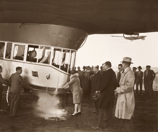 Mrs. Karl Arnstein christening Mayflower with a flask of liquefied air, May 21, 1929 