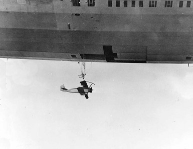 N2Y-1 training plane beneath trapeze and T-shaped opening of Akron's hangar deck