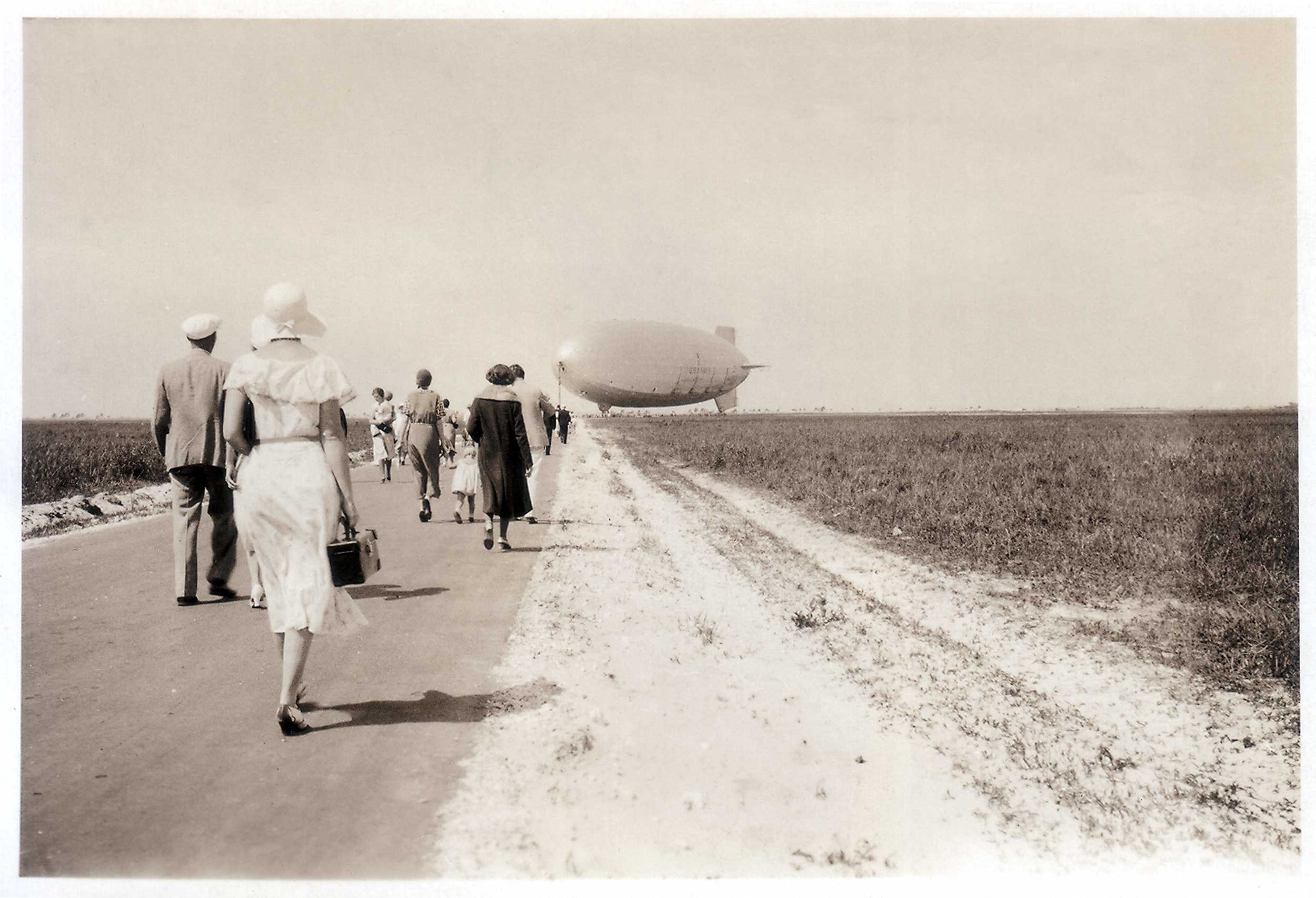 People walking to see USS Macon
