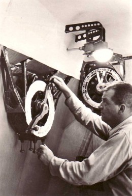Chief Engineer Rudolf Sauter at the engine telepgraphs in the Engineering Room along the keel.